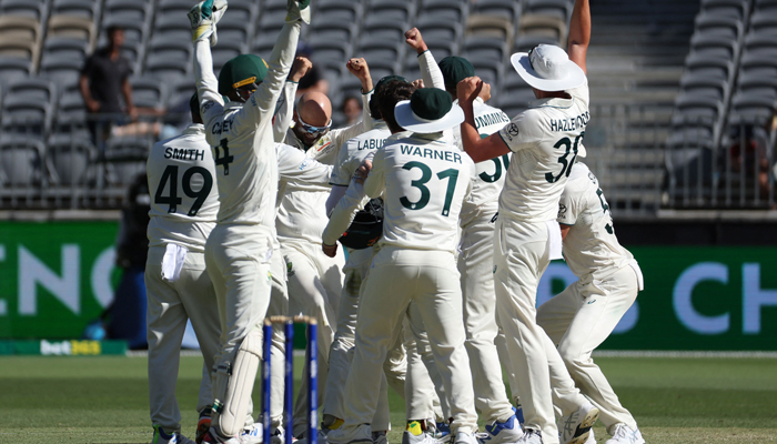 Australias Nathan Lyon (centre L) celebrates with teammates after taking his 500th wicket, Pakistans Faheem Ashraf, during day four of the first Test cricket match in Perth on December 17, 2023. — AFP