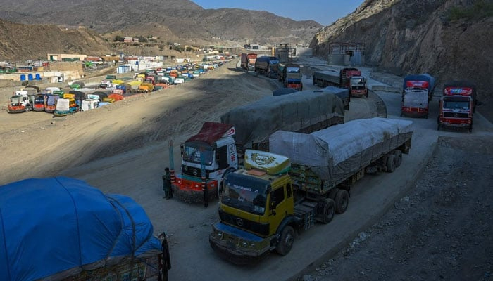 This representational picture on September 11, 2023, shows trucks parked along a road and a parking area in Torkham. — AFP