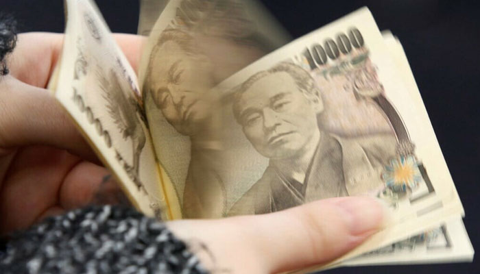 This photo illustration shows Japanese 10,000 yen banknotes in Tokyo on November 19, 2021. — AFP