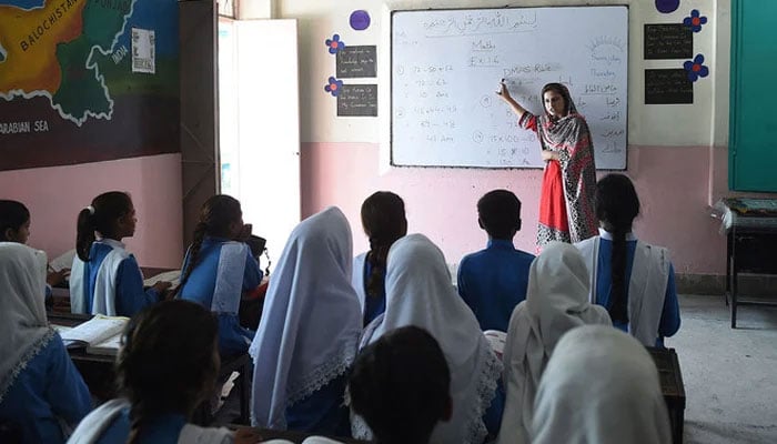 This photograph shows students attending a class at a school on the outskirts of Lahore. — AFP/File