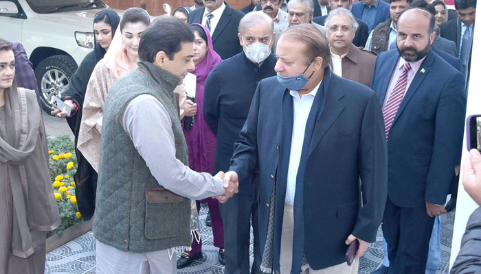 PMLN Quaid and former Prime Minister Muhammad Nawaz Sharif (R) handshake with Hamza Shahbaz Sharif before the 13th meeting of the partys parliamentary board on December 19, 2023. — Facebook/PML(N)