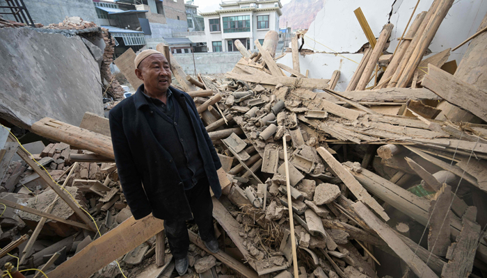 A man inspects a damaged building after an earthquake at Dahejia in Jishishan County in northwest Chinas Gansu province on December 20, 2023. — AFP