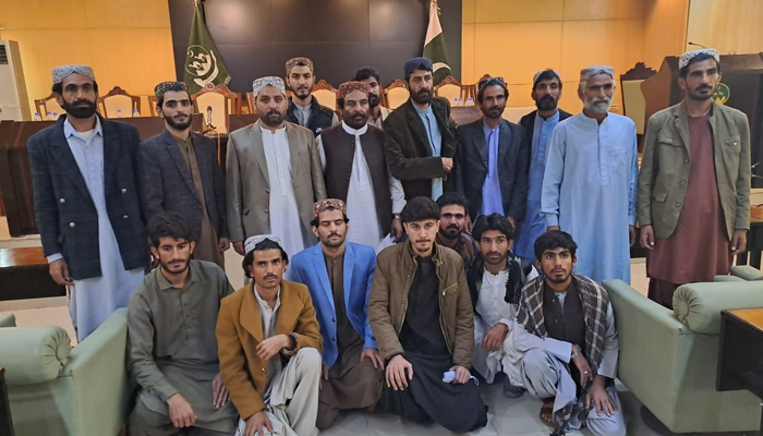 This image shows a group photo of the separatist group fighters after giving up arms on December 20, 2023. — X/@anwaar_kakar