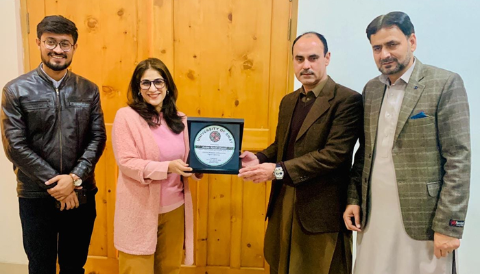 Institute of Business Administration (IBA) Karachis Amber Rahim Shamsi receives a souvenir from the officials of Swat University on December 21, 2023. Facebook/University of Swat