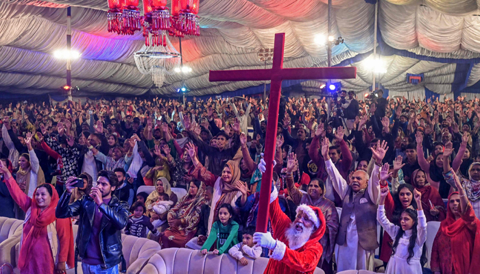 Christian devotees take part in a special mass ahead of Christmas, at a church in Lahore on December 20, 2023. — AFP