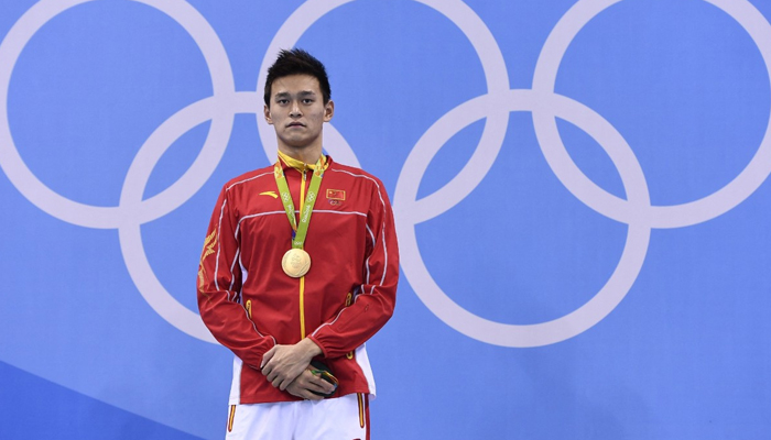 Chinas Sun Yang poses with his gold medal on the podium after winning mens 200m freestyle final at the Rio 2016 Olympic Games. — AFP/File