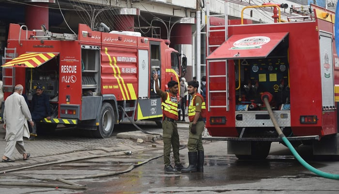 Firefighters douse the fire at a shopping mall in Karachi on November 25, 2023. — AFP