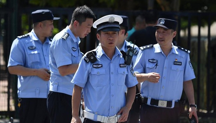 Chinese police personnel can be seen in this image. — AFP/File