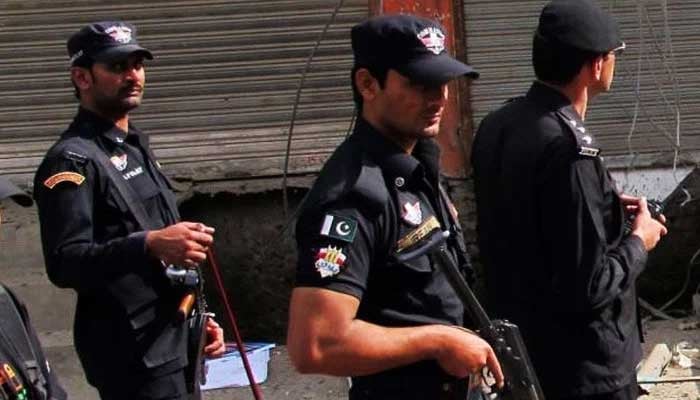 Counter-Terrorism Department personnel stand guard in a street. — AFP/File