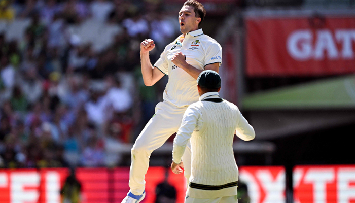 Australias Pat Cummins celebrates dismissing Pakistan´s batsman Barbar Azam on the second day of the second cricket Test match between Australia and Pakistan at the Melbourne Cricket Ground (MCG) in Melbourne on December 27, 2023. — AFP