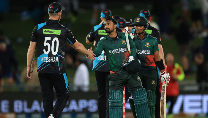 Bangladeshs Litton Das (C) shakes hands with New Zealands James Neesham (L) after Bangladeshs victory in the first T20 cricket match at McLean Park in Napier on December 27, 2023. — AFP