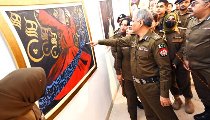IG Punjab among others Police officials look at the artwork in the Punjab Police Art Exhibition 2023 on December 27, 2023. — Facebook/Punjab Police Pakistan