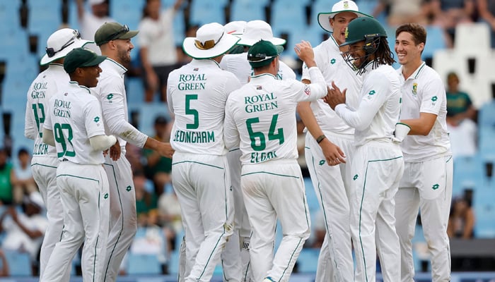 South Africas Nandre Burger (R) celebrates with teammates during the third day of the first cricket Test match between South Africa and India at SuperSport Park in Centurion on December 28, 2023. — AFP