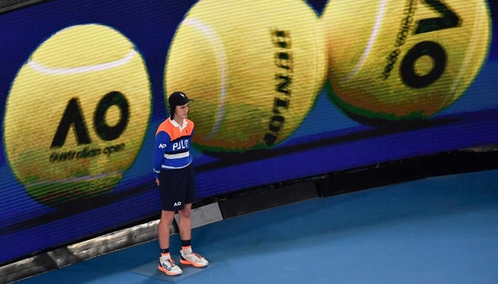 A person stands on a tennis field. — AFP/File