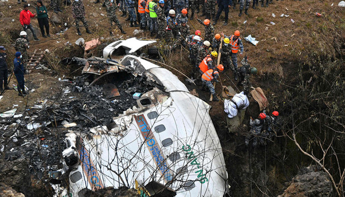 Rescuers pull the body of a victim who died in a Yeti Airlines plane crash in Pokhara, Nepal on January 16, 2023. - AFP