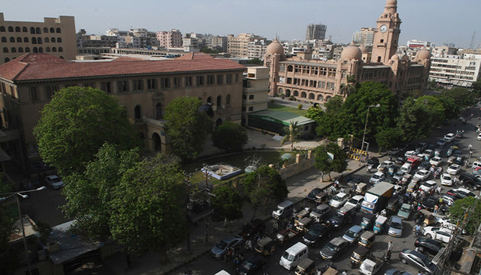 Commuters make their way along a busy street in Karachi. — AFP/File