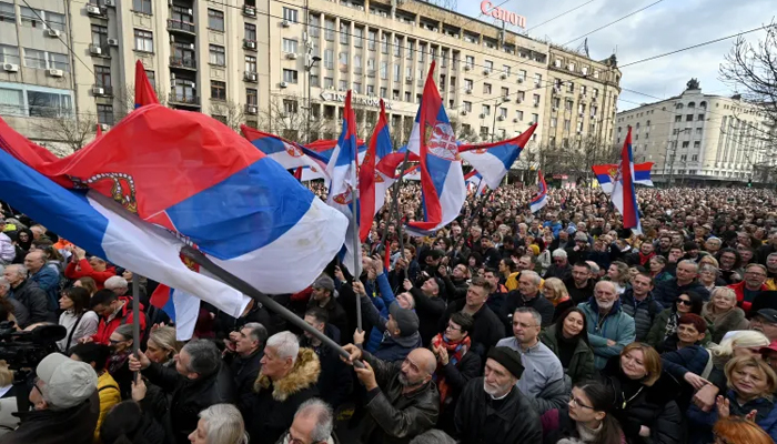 Protesters wave Serbian flags as they attend a rally by the Serbian pro-democracy movement in Belgrade on December 30, 2023. —AFP