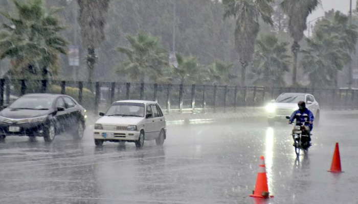 Motorists drive slowly on a wet road on a rainy morning as Islamabad receives a sudden downpour signalling a refreshing change in weather after the prolonged dry spell.—ONLINE/File