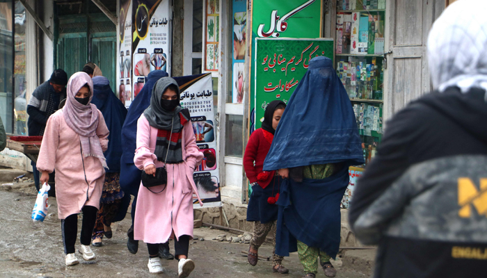 Afghan women walk along a street at a market in the Fayzabad district of Badakhshan province on December 12, 2023. — AFP