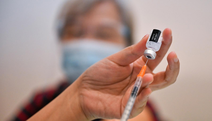 A medical staff prepares to administer a dose of a vaccine. — AFP