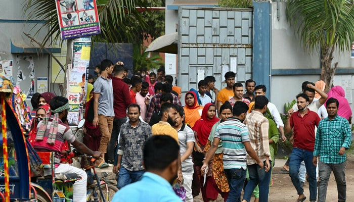 Garment workers walk off a factory at lunch break in Ashulia on November 8, 2023, a day after the Minimum Wage Board authority declared the minimum wage of 12,500 taka ($113) for garment workers. — AFP File