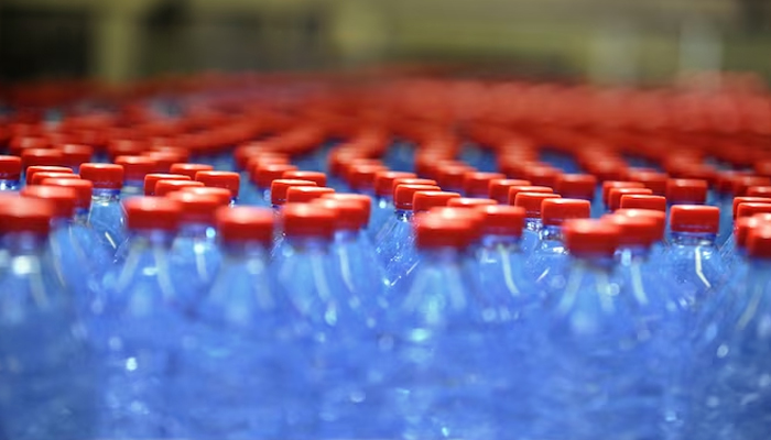 Bottles are seen on a production line of the mineral water bottling plant.—AFP/File