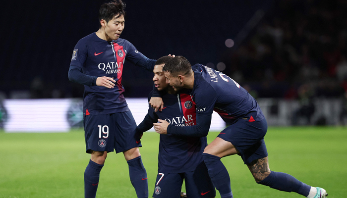 PSGs Kylian Mbappe (C) celebrates with Lucas Hernandez (R) and Lee Kang-in after scoring teams second goal during the French Champions Trophy football match against Toulouse FC in Paris on January 3, 2024. — AFP