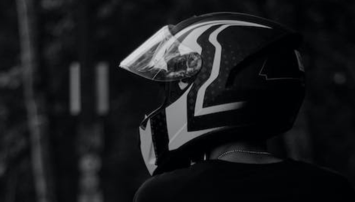 This representational image shows a bike rider wearing a helmet. — Pexels