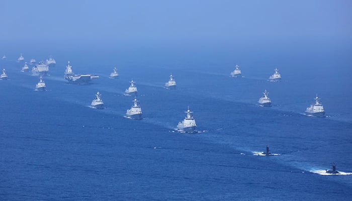 Aircraft carrier Liaoning, submarines, vessels, and fighter jets take part in a review in the South China Sea. — Xinhua/File