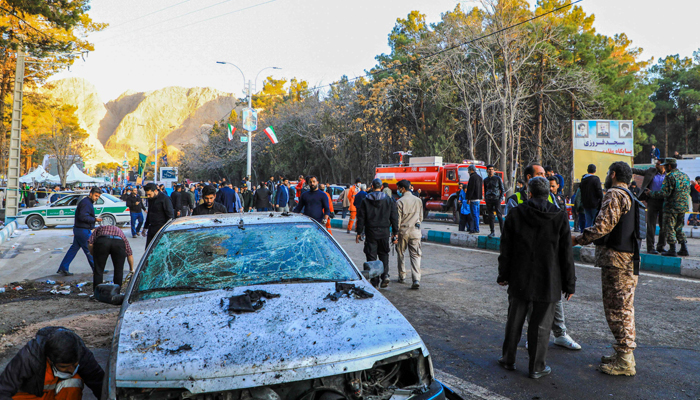 This picture shows people and Iranian emergency personnel at the site of explosions that occurred during the anniversary of Qasem Soleimani, near the Saheb al-Zaman Mosque in Kerman on January 3, 2024. — AFP