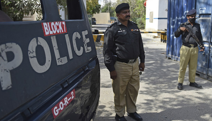 Police stand guard on a street in Karachi. —AFP/File