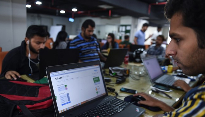 This photograph shows Pakistani employees of an online marketplace company in Karachi. — AFP