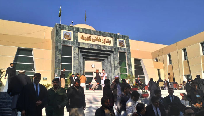 People are seen gathered outside the Peshawar High Court (PHC). — Geo News/File