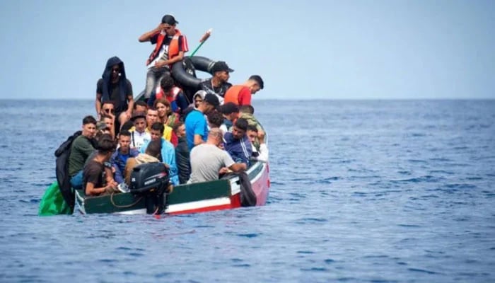 A boat carrying migrants is stranded in the Strait of Gibraltar before being rescued by the Spanish Guardia Civil, last September. — AFP/ File