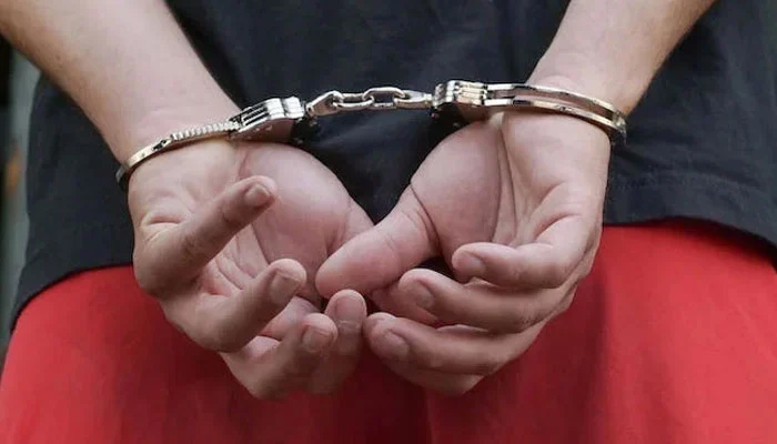 This image shows a handcuffed person. — Pexels