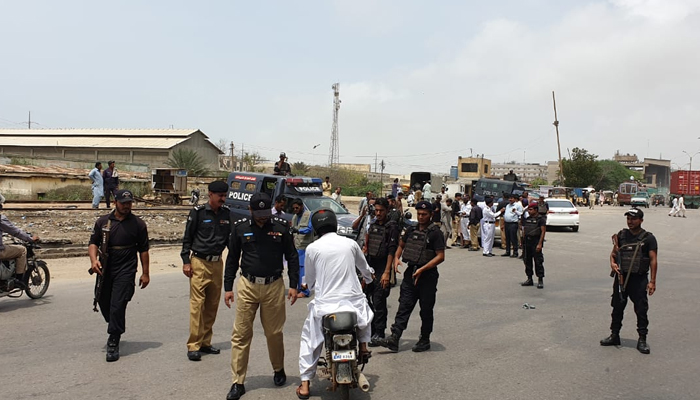 Sindh Police personnel can be seen while patrolling and checking civilians in this image. — Facebook/Sindh Police