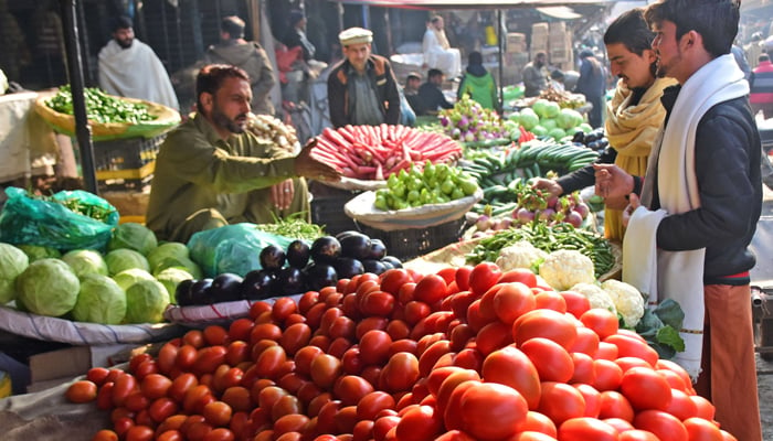 People are buying vegetables from a vendor at the Fruit and Vegetables Market in Islamabad on January 6, 2024. — Online