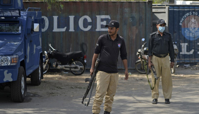 Police officials stand guard in a street. — AFP/File