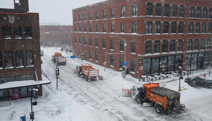 Plow trucks move through downtown streets as Winter storm Gerri arrived in Iowa four days before the caucuses on January 12, 2024 in Des Moines, Iowa. — AFP