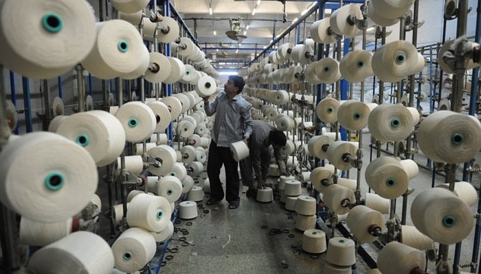 In this photo, a man can be seen working in a textile factory in Pakistan.—AFP/File