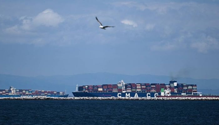A ship carrying cargo shipping containers sails in the Pacific Ocean outside the Port of Los Angeles in Los Angeles, California on June 7, 2023.—AFP