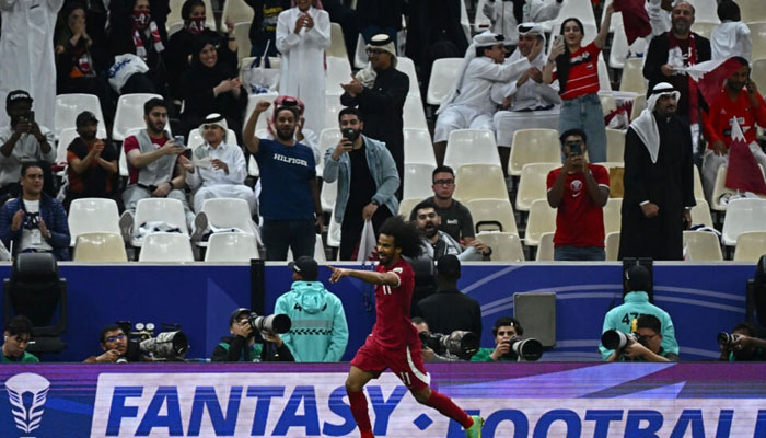 Qatars forward Akram Afif celebrates after scoring his teams third. — AFP