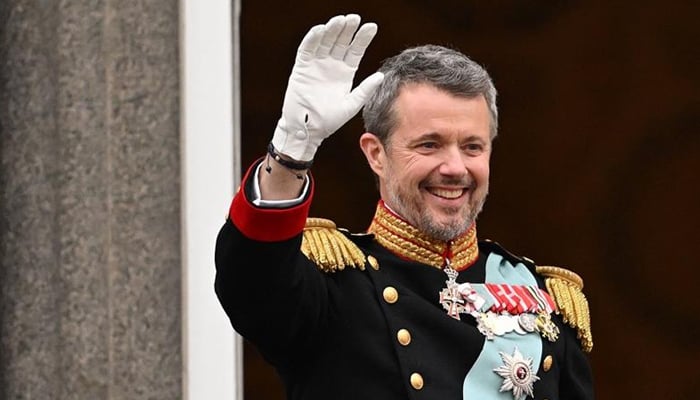 King Frederik X of Denmark waves to the crowd from the balcony of Christiansborg Palace in Copenhagen, Denmark on January 14, 2024. — AFP