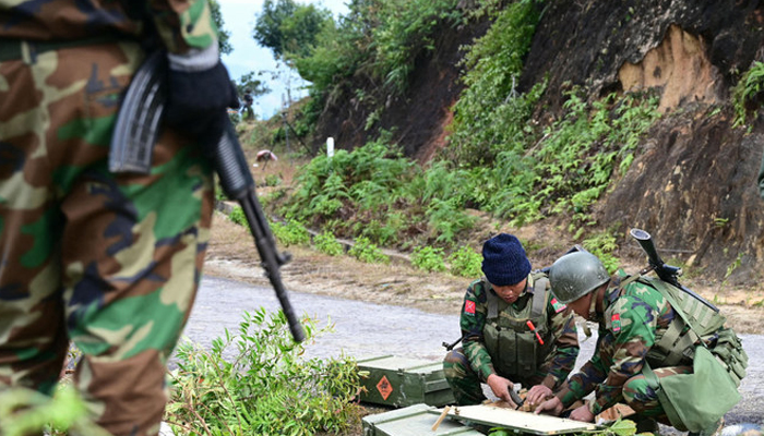 Taang National Liberation Army fighters prepare their weapons amid clashes with Myanmars military in Namhsan town, in the northern Shan State, on December 13, 2023. — AFP