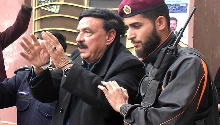 Police escort The chief of Awami Muslim League (AML) and former Interior Minister Sheikh Rashid Ahmed into an Islamabad court. — INP/File