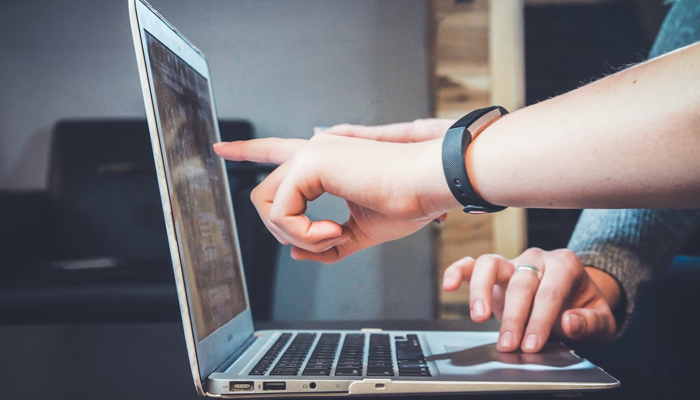 This representational image shows fingers pointing to a laptop screen. — Unsplash/File