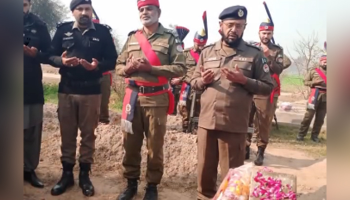 Police officials offer Fateha on police martyred Sub-Inspector Muhammad Waseem, Constable Maswar Ali, and Constable Sarwar Begs graves on their death anniversary on January 18, 2024. — Facebook/Capital City Police Lahore