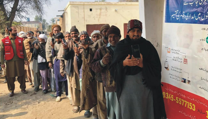 People stand in a queue during a cash distribution ceremony by the Pakistan Red Crescent Society KP on January 18, 2024. — Facebook/Pakistan Red Crescent Khyber Pakhtunkhuwa Provincial Branch