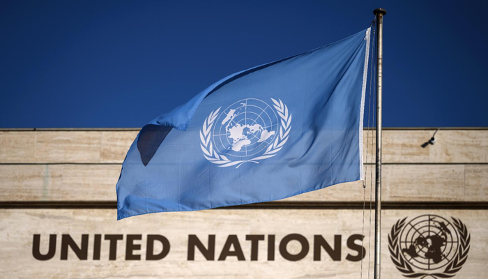 A flag flutters in wind at the main entrance of the building which houses the United Nations Offices in Geneva. — AFP/File