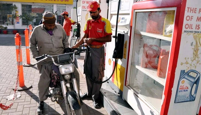 Fuel station worker filling petrol in a motorcycle at a petrol pump on January 29, 2023. — PPI